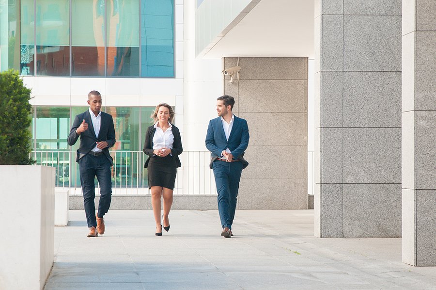 Business colleagues walking outside office building
