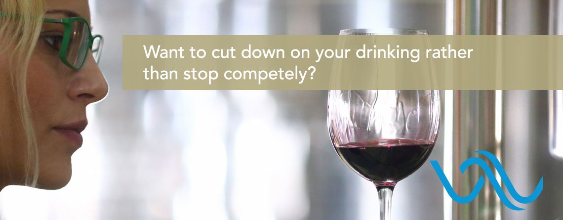 Woman thoughtfully considering a glass of wine — exploring moderation as a treatment option